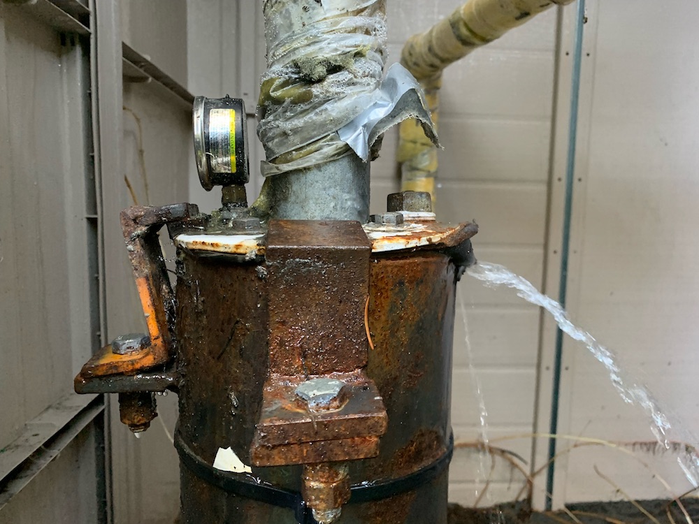 Artesian water pouring out of a broken well head